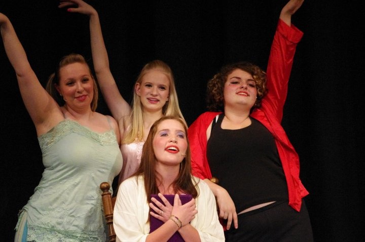 AHS alumnus Molly Sgrecci and Tori Clodfelter, along with current students junior Skye Lindberg and senior Paulina Stehr, act in a  scene in AHS’ previous spring musical, “Grease.”