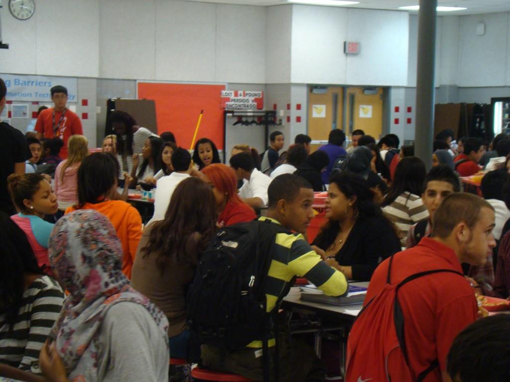 Students eat lunch in the cafeteria at the beginning of the school year.