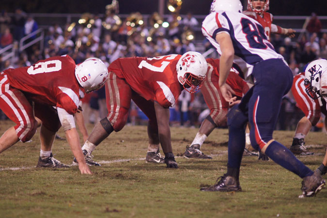 Senior Ali Musa (#67) lines up to block the incoming blitz by Woodson. The Atoms lost by a touchdown to the Cavaliers.