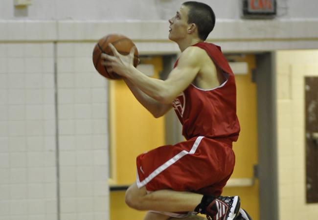Senior David Croghan jumps in the air to make a lay-up. Croghan recently returned from a concussion.