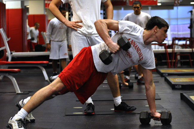 Junior Justice Garrish lifts after school for varsity wrestling practice.  Athletes can gain muscle before competitions through weight training classes. Many high school sports discourage and sometimes ban the use of energy supplements.