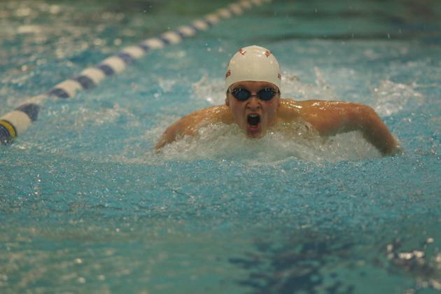 Sophomore James Barker swims fly during the district meet. Although Barker did not qualify for the regionals, the boys squad sent multiple swimmers to the competition.