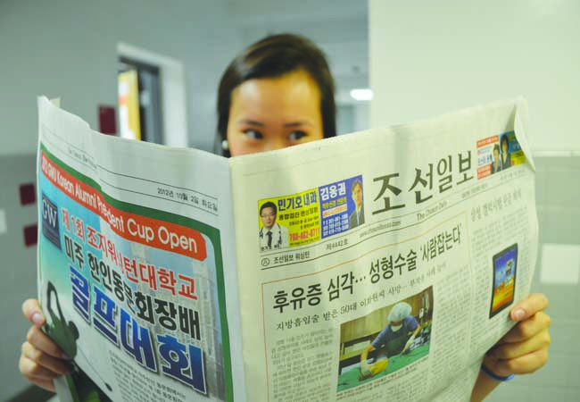 Junior Jennifer Nguyen reads a Korean newspaper to stay informed about current events and international news