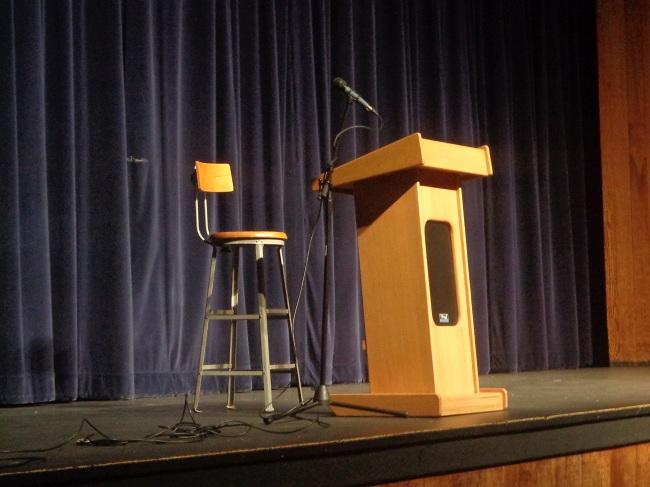 A chair and podium were set up prior to Mr. Greenbaum taking the stage.