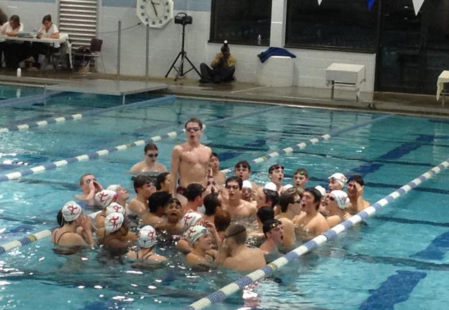The swim team gets pumped up before their meet against Lee HS. 