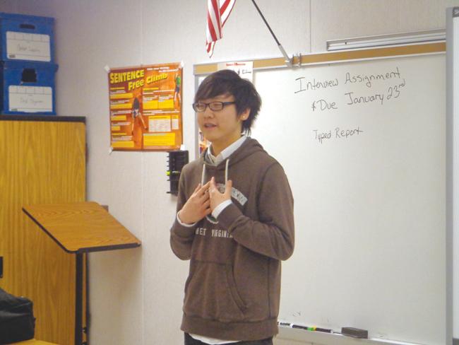 Senior Brian Quang performs an impromptu speech about the value of Starbucks. 