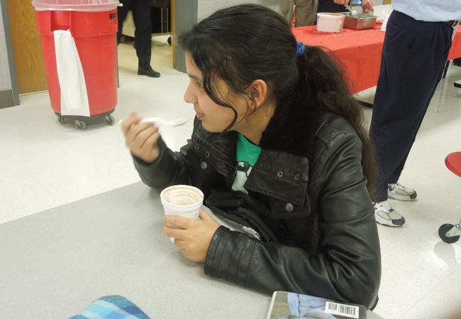 Students celebrating her achievement by eating her ice cream