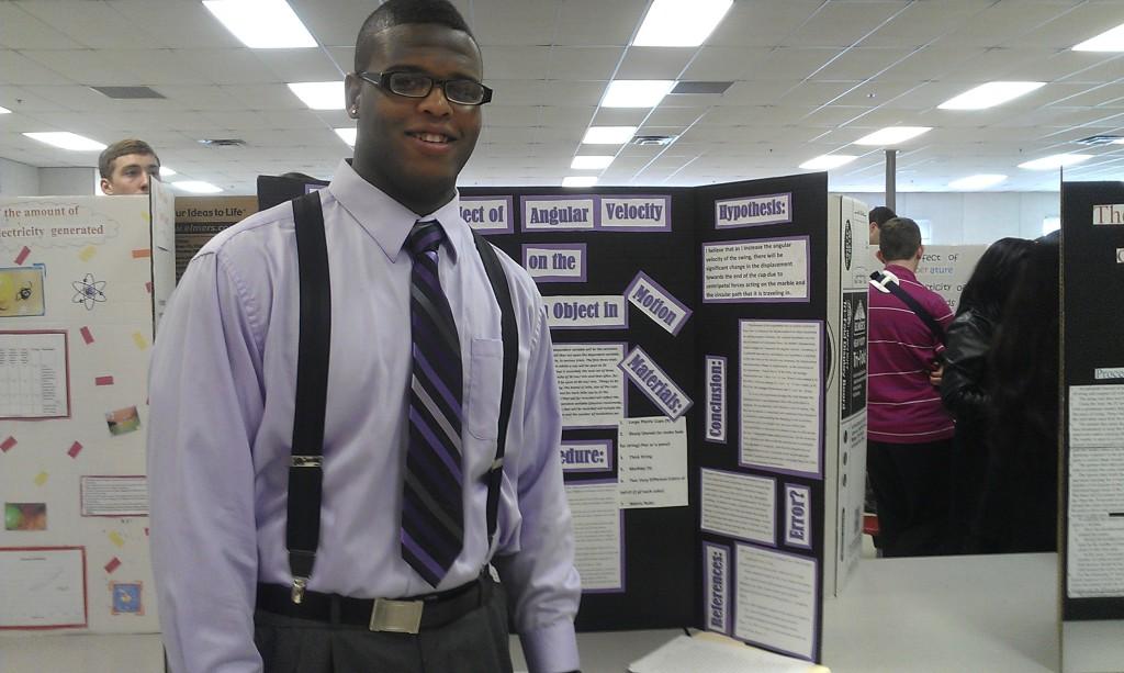 Senior Bryan Jefferson stands in front of his individual science experiment.