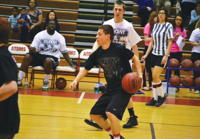 Senior Sanar Shamdeen brings the ball down the court in last years student vs. faculty basketball game. 