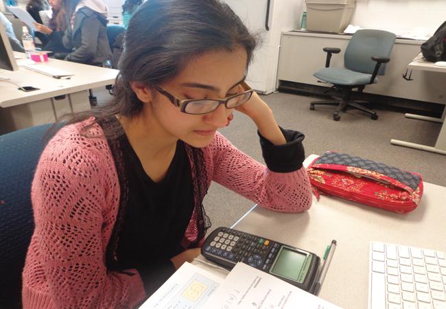 Junior Rizwana Noor stresses over her math homework; stress developed from school helps account for teen depression. 