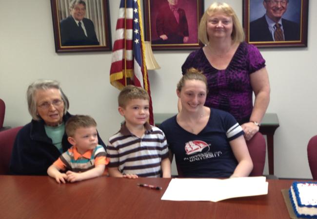 Athlete officially signs with college for swimming