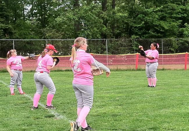 Varsity softball warms up for a recent game.
