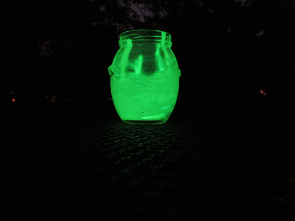 Let your dried jars sit directly under a light source for a little while so the paint has time to charge. You can now enjoy the glow-in-the-dark effects!