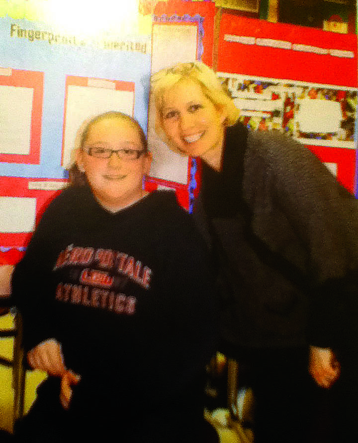 Swansbrough posing with a student in the 2013 Poe Middle School yearbook