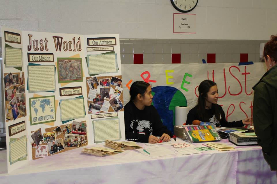 Senior Kristina Nguyen and junior Soriya De Lopez present information about the Just World Interact Club at last years festival.