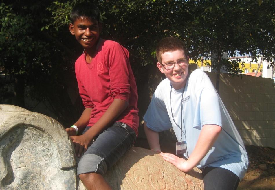 Peters and Mano sitting on a stone elephant on Fun Day