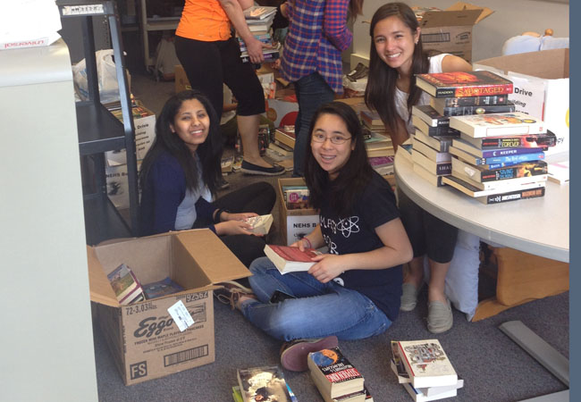 NEHS organizes books donated.