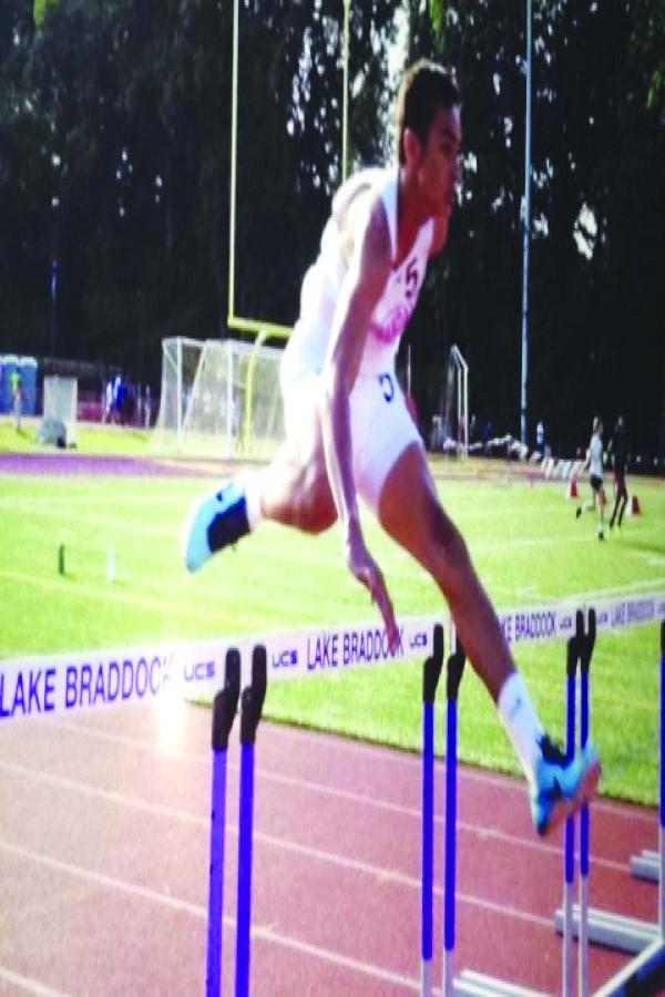 Sophomore Joseph McCoy hurdles over the bar in one of last years meets. 