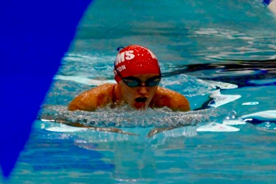 Swimmer Ashley Britton comes up to take a breath while preforming the 100 meter breaststroke.