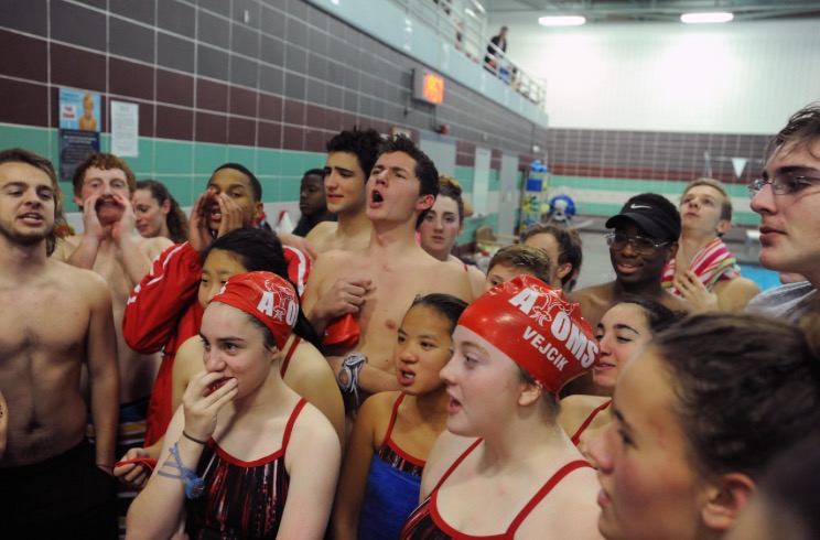 Senior Ben Padrutt (center) cheers with his teammates before a meet at South Run