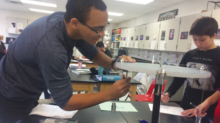Junior William Wheatley leads a physics lab on force. 