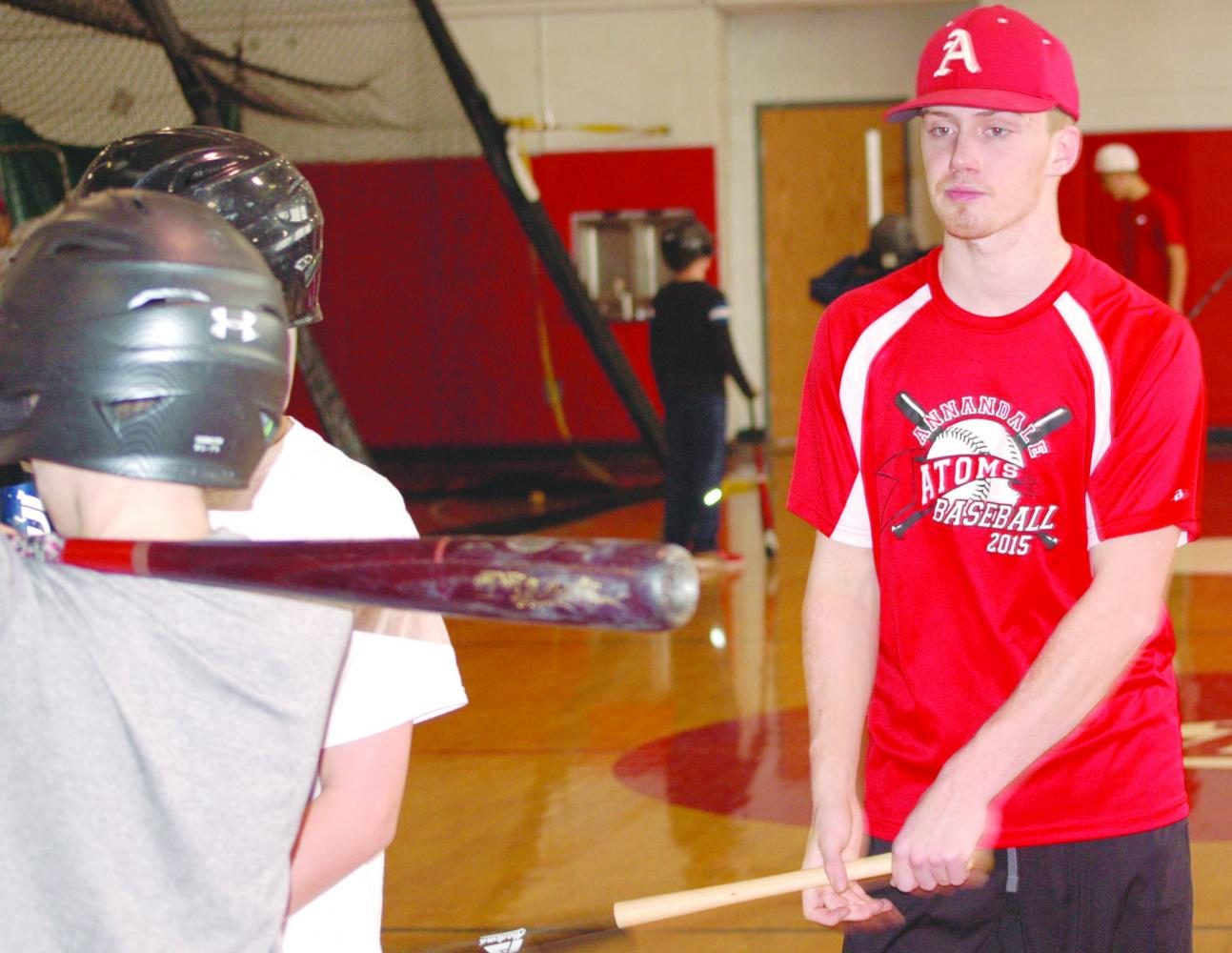 Senior Liam Conroy working with future student-athletes at a session of the winter baseball camp on January 22.