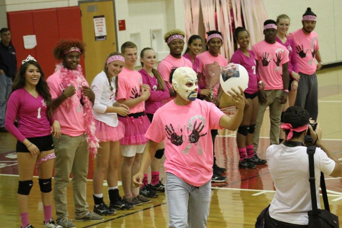 The Atoms volleyball team takes part in their dig pink tradition to raise awareness about breast cancer before a game last season. 