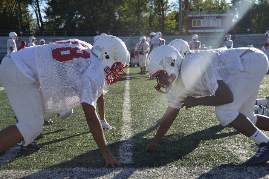 Atoms football players go head to head in team drills during a practice held on Oct. 16. As seen above, players make head to head contact in not only games but in practice as well. 