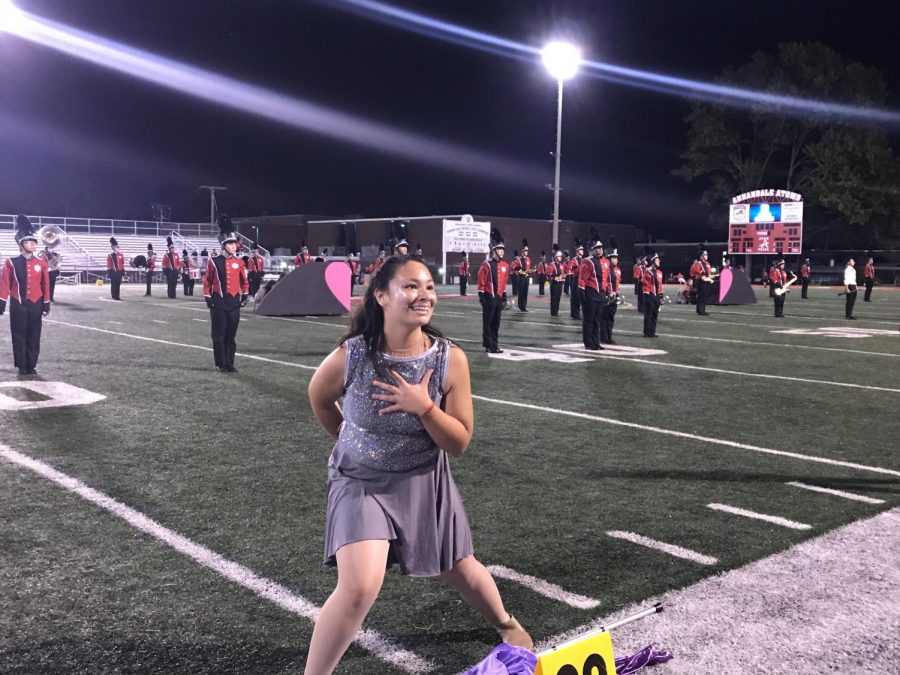 Senior Marina Chen finishes her choreography as a color guard member