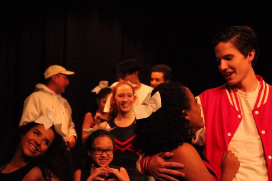 Cheerleading squad supports Miles the football player, played by Junior Cort Hollis, who is holding his girlfriend Agnes Evans, played by Junior Rediate Zewdu, after Miles scored a winning touchdown during their game.