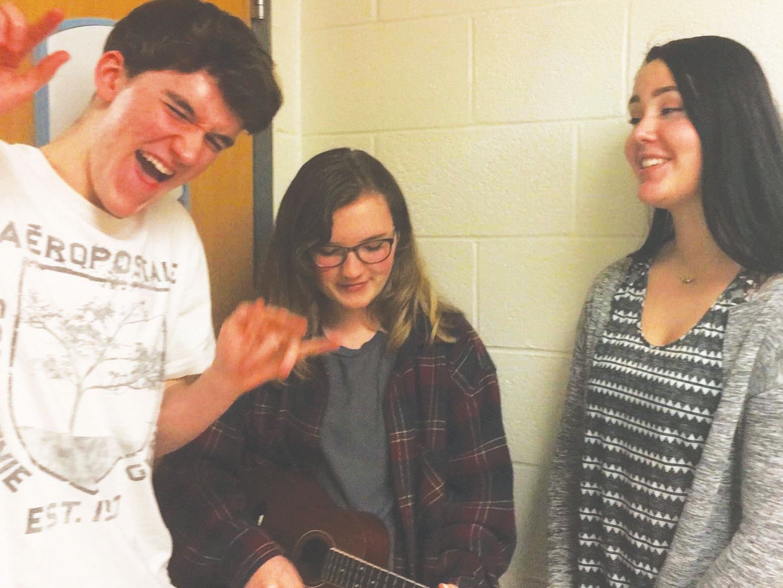 Junior Kyle Dalsimer, Junior Emily Trachel and Ioana Martin practicing their vocals for Singing Valentines in the hallways.