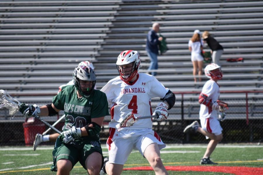 Junior Alex Bellem fights for the ball against Falls Church last year on April 10.