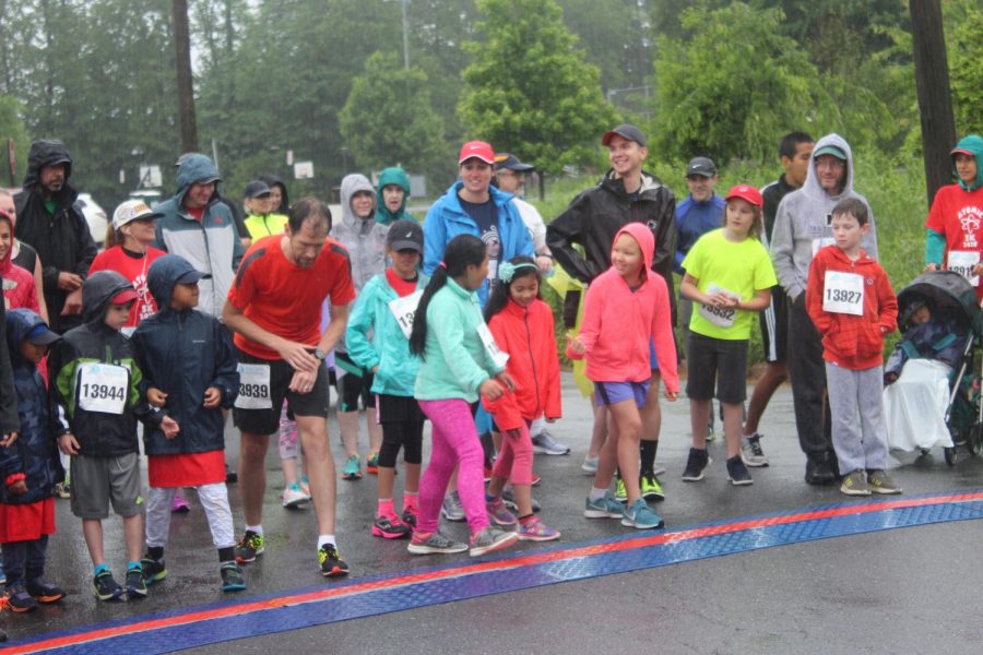 About 50 participants lined up in the rain at the starting line in the annual Atoms 5K race. The first place runner crossed the finish line at about 17 minutes. 