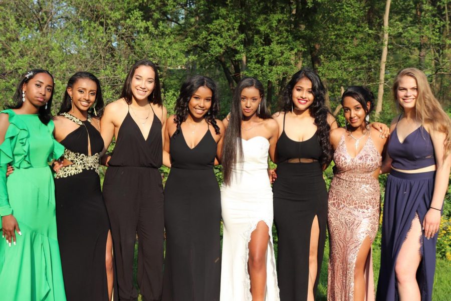 A group of prom attendees pose for a picture prior to the dance. 