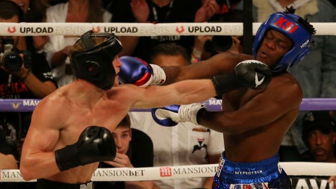 Logan Paul (left) and KSI (right) exchange blows during the third round of their fight on August 25. The fight consisted of six, three minute rounds.