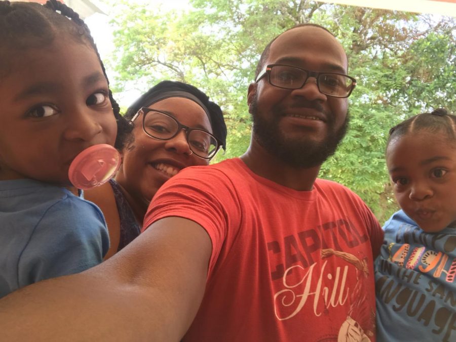 Desrivieres takes a picture with his wife and two kids outside of his house in Jamaica over the summer.
