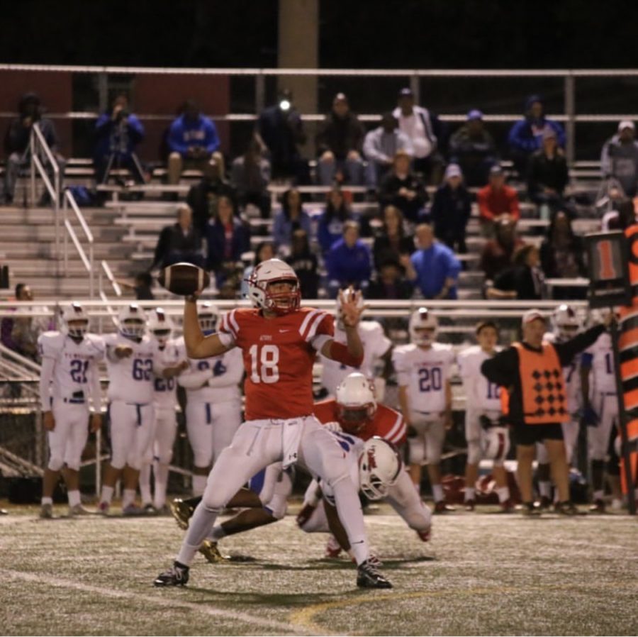 Senior starting quarterback Devin Gill drops back for a pass during a game. 