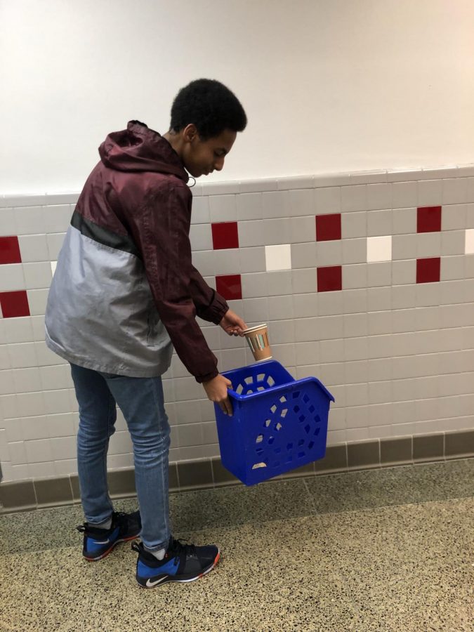 Sophomore Abdullahi Ali recycles his coffee cups. Recycling is an easy way to help the environment, Ali said. It requires no effort, so I dont understand why other people dont do it. 