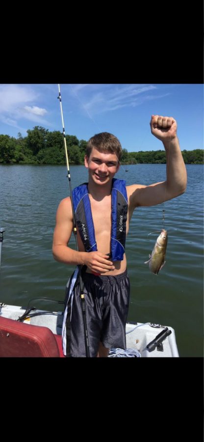 Senior Phillip Bartlow poses with a fish that he caught while deep sea fishing in Clearwater, Florida.