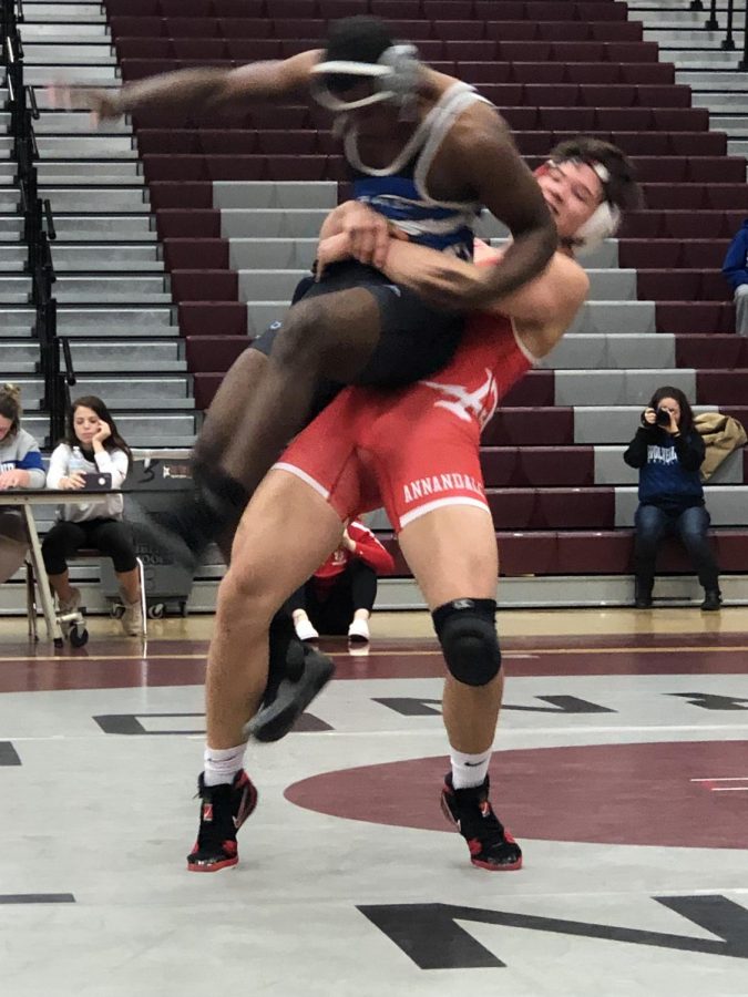Junior Patrick Lee takes down an opponent during a district tournament at Mount Vernon High School on Jan. 16. The tournament was the second between all teams in the Gunston District and the last before the district finals.