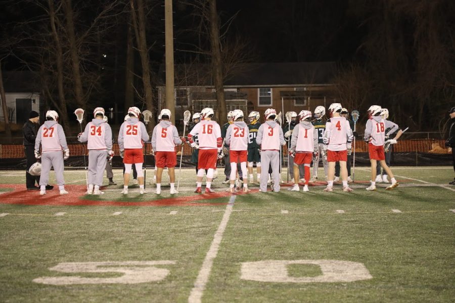 The+boys+varsity+lacrosse+team+lines+up+before+their+first+regular+season+game+on+March+14+against+Washington-Lee.