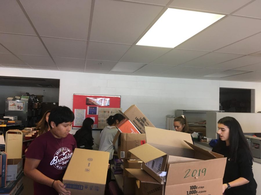 Key Club members earn points by volunteering to unpack new English textbooks. “It was nice to see us all working together,” club President Megan Le said.