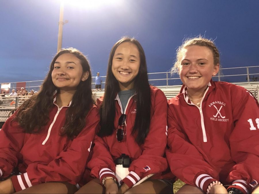 Senior Samantha Rodriguez, junior Natalie Nguyen, and sophomore Lilli Dalrymple ,watch the Atoms take on West Springfield