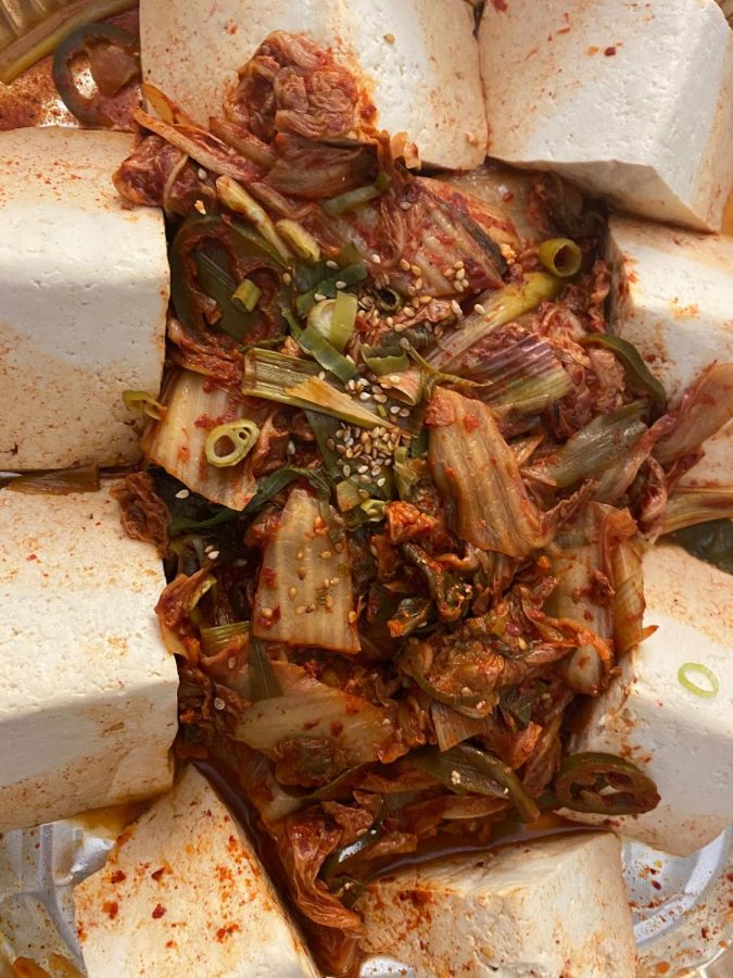 The dish comes with tofu and kimchi.