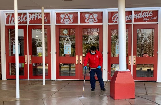 AHS staff power wash the front of AHS in preparation for the return of students. Students are set to return to in-person instruction on March 2 and March 9. This comes as thousands of FCPS staff are being vaccinated for Covid-19.