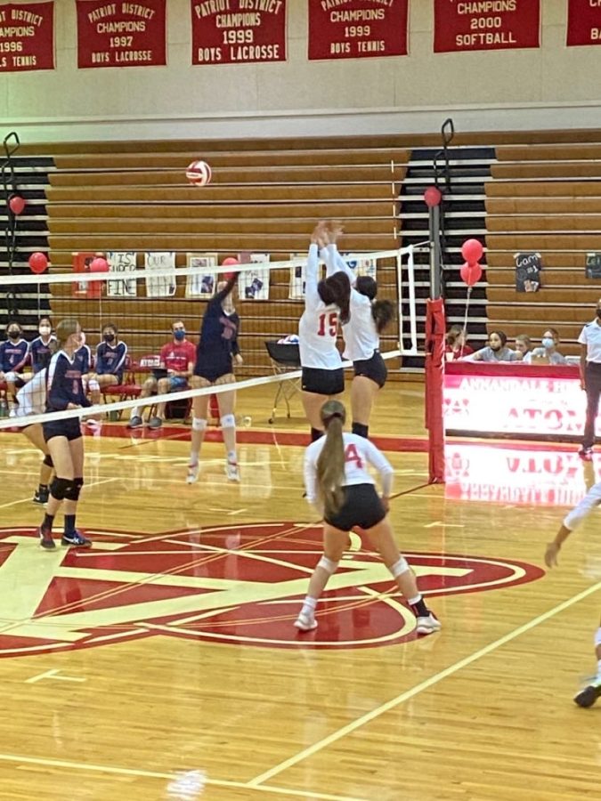 AHS volleyball players jump up to try to block a spike in an unfortunate 3-1 loss to Edison.