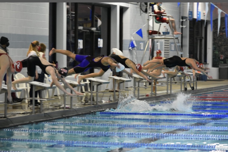 Atoms swimmers Ashley Holcolmb, Maya Mann, Jana Russell and Madison Cruz dive off of the starting block in the 2020 District Finals. 