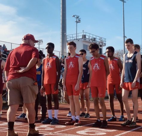 Atoms distance runners wait to start the 1600m race during a meet at Thomas Jefferson.