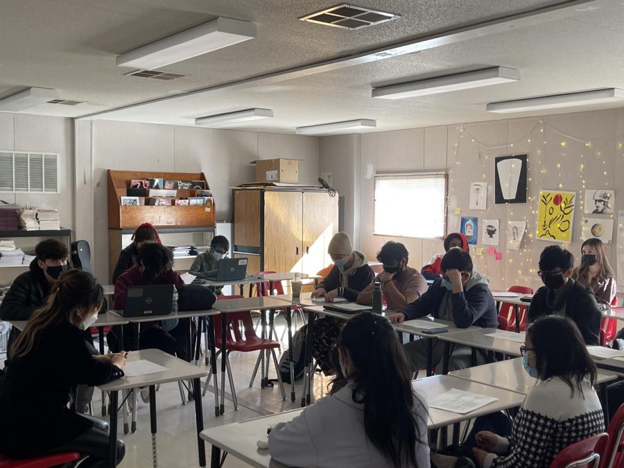 Students in IB Language and Literature participate in a Socratic Seminar while wearing masks.