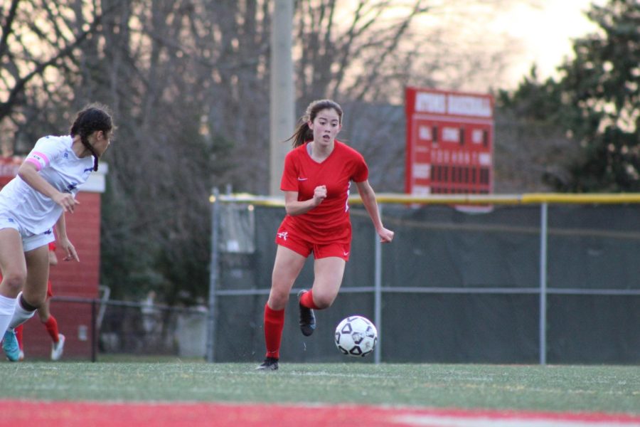 Junior Chelsi Lilli dribbles the ball up the field in pursuit of the goal to put the Atoms ahead against Fairfax.